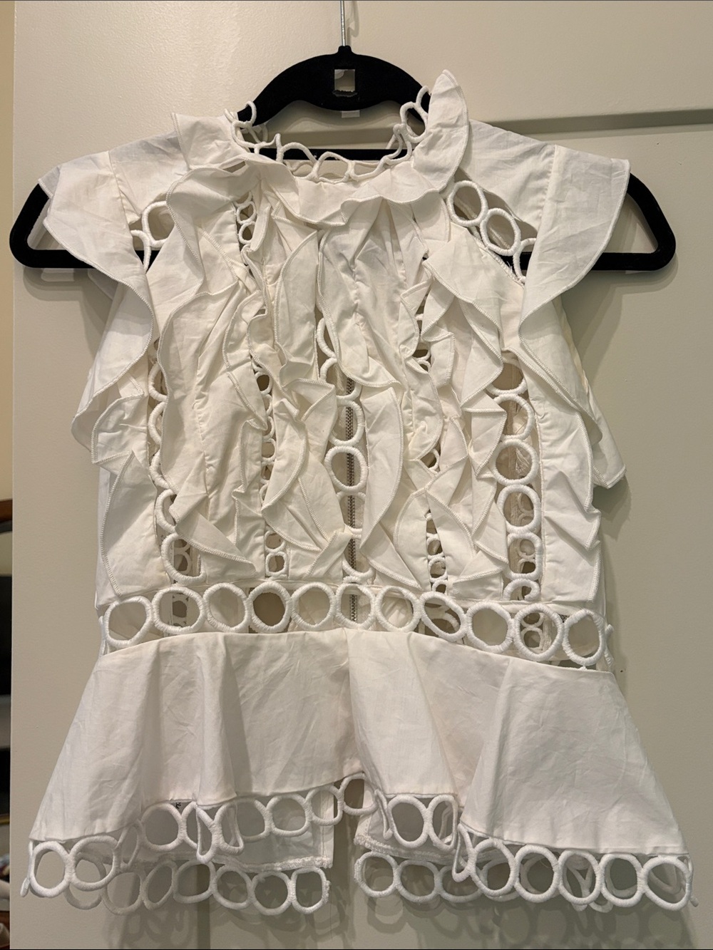 the clothing company White Ruffle Eyelet Peplum Blouse
